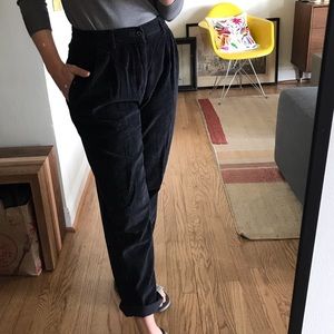 well-loved pair of faded black corduroy trousers